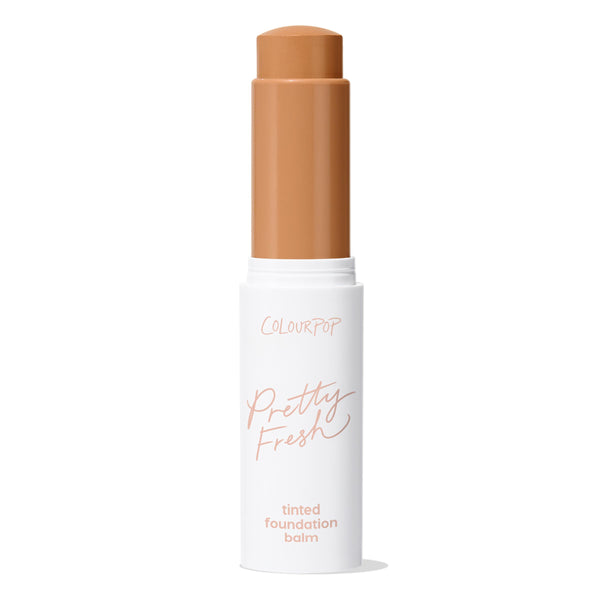 ColourPop Pretty Fresh Tinted Foundation Balm in Dark 17, open twist-up stick showing a warm deep tan shade, standing upright in a white tube with peach βPretty Freshβ lettering on a clean white background.
