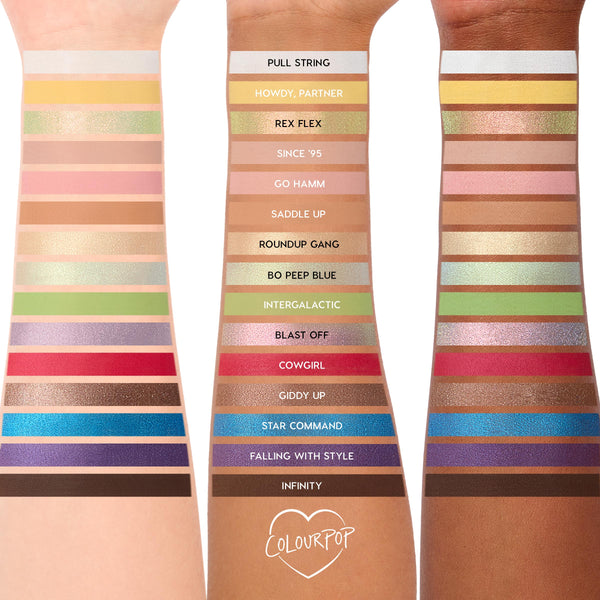 ColourPop The Toys Are Here shadow palette swatches line three arms, showcasing 20 Toy Storyβinspired shades from neutral mattes to metallics in green, blue, red, purple, and gold, with labeled strips for each shade on a white background.