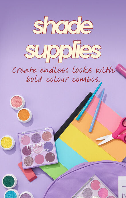 ColourPop It’s My Pleasure eyeshadow palette and Super Shock shadows arranged flat lay with teal brushes, pink scissors, and rainbow paper on a pastel purple desk, headline “shade supplies” promoting bold color combos for back-to-school.