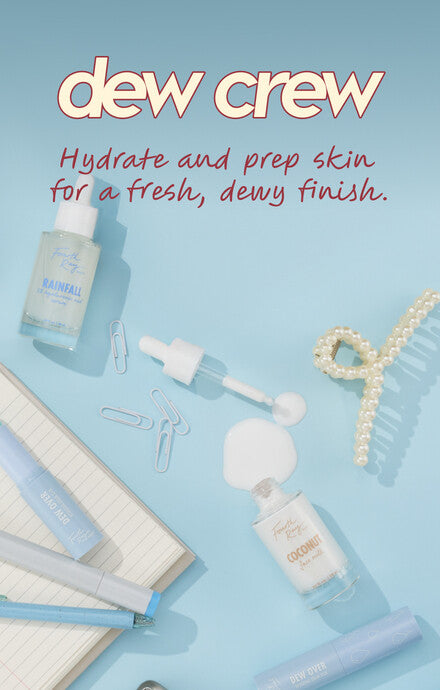Hydrating skincare set featuring Rainfall and Coconut serums with dropper and Dew Over stick, arranged flat-lay on a light blue desktop beside a notebook, pens, paper clips, and a pearl hair clip, promoting a fresh, dewy finish; ColourPop.