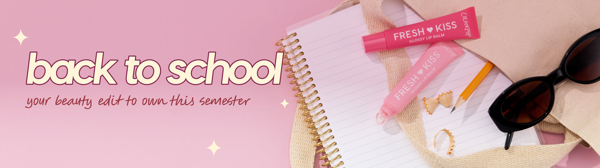 ColourPop Fresh Kiss Glossy Lip Balm tubes arranged for back‑to‑school, spilling from a canvas tote onto a spiral notebook with pencil and shavings, next to black sunglasses on a pink backdrop with bold “back to school” banner text.