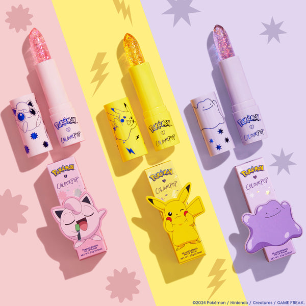 Thunderbolt, a ColourPop pH Lip Balm featuring Pikachu, stands uncapped with a sparkly gold translucent bullet; bright yellow tube and matching box centered on a pastel yellow stripe, flanked by pink and purple character balms with star and lightning motifs.