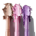 ColourPop Shadow Stix Cool Metallics eyeshadow trio displayed with creamy shimmer swatches - champagne taupe, icy pink, and lavender purple - smeared behind the sticks on a white background for shade comparison.