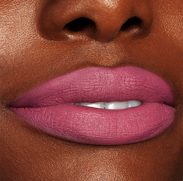 Byron Babe ColourPop Lippie Stix coating lips in a matte mauve‑pink, delivering full‑coverage color with a soft‑focus finish, shown in a close-up beauty shot highlighting smooth texture and precise edges.