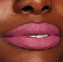 Byron Babe ColourPop Lippie Stix coating lips in a matte mauve‑pink, delivering full‑coverage color with a soft‑focus finish, shown in a close-up beauty shot highlighting smooth texture and precise edges.