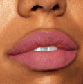 Close-up lips wearing Cami, a dusty rose ColourPop Lippie Stix, showing full, even coverage with a soft-matte finish; teeth slightly visible, studio lighting highlights smooth texture.