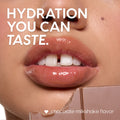 Glossy, hydrated lips coated with the Triple Chocolate ColourPop Lip Care Kit, delivering chocolate milkshake flavor and high shine, with a broken chocolate bar at the lower edge in a tight, close-up beauty shot.