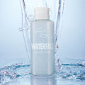 Fourth Ray Beauty Waterfall Gentle Tonic face toner standing upright as water splashes around it, showcasing a pale blue 4.15 fl oz bottle with white flip cap; hydrating ColourPop Face Toner in a fresh waterfall setting.