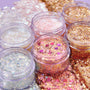 Spinner glitter gel jars sparkle with iridescent silver, gold, and pink shades - some with heart confetti - swatched thickly around the clear pots; ColourPop Glitter Gel shown in multiple textures and chunky blends.