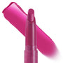 ColourPop Lippie Stix Heart On stands upright with the bullet exposed, a vibrant fuchsia swatch streaked behind it, showcasing creamy, high-pigment payoff in a slim, twist-up tube on a white background.