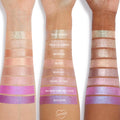 ColourPop Stargaze Jelly Much Shadow swatched on three arms in a gradient of shimmering pastel to vivid purple eyeshadow shades, showing buildable pigment and reflective finish on multiple skin tones for US makeup lovers.