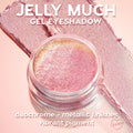 ColourPop Jelly Much Shadow Stargaze, an open jar of sparkly pink-to-gold duochrome gel eyeshadow, set over metallic swatches on a blush-pink backdrop, showcasing vibrant pigment and reflective finish.