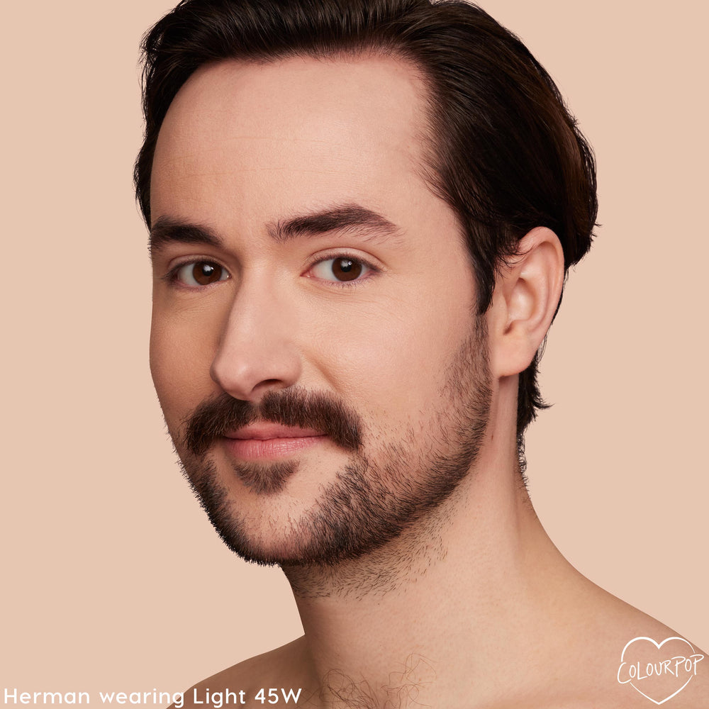 Model wearing Light 45 W shade of ColourPop Pretty Fresh Creamy Concealer, showcasing smooth, natural medium coverage with warm undertones on under-eyes and complexion in a close-up against a soft beige backdrop.
