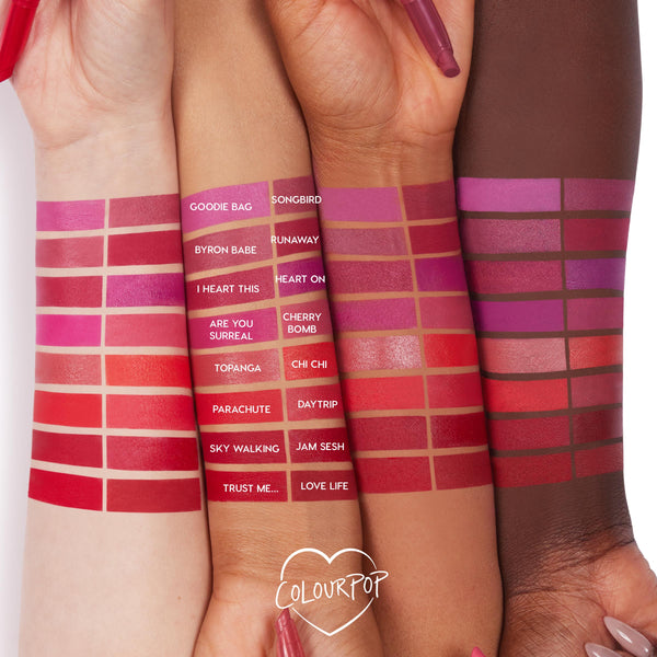 Byron Babe ColourPop Lippie Stix swatched on three arms, showcasing its rosy mauve shade among labeled swatches, with a Lippie Stix pen held near the wrists and a ColourPop heart logo on a white background.