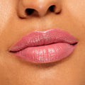 Glossy lips wear ColourPop Lippie Stix in Felt Cute, a soft pink shade applied evenly with a creamy, high-shine finish, shown in an extreme close-up lip swatch for color and texture detail.