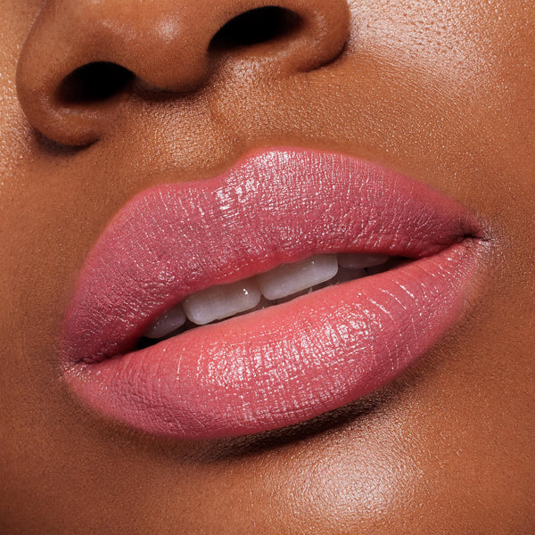 Lips wearing ColourPop Lippie Stix in Felt Cute, a creamy soft pink, reflecting a glossy satin sheen; extreme close-up shows full, even coverage and smooth, hydrated texture for a natural everyday lip look.