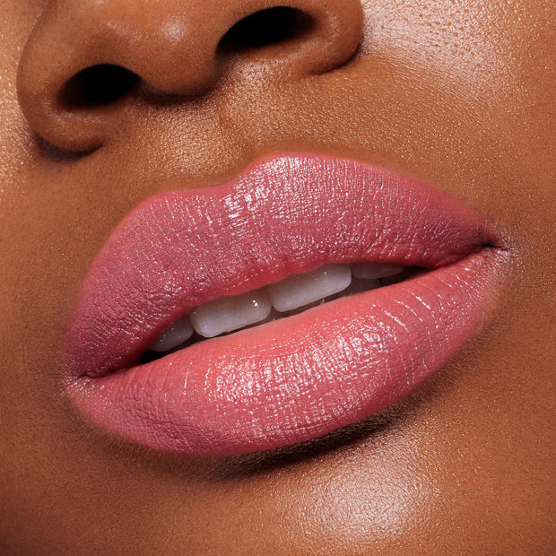Lips wearing ColourPop Lippie Stix in Felt Cute, a creamy soft pink, reflecting a glossy satin sheen; extreme close-up shows full, even coverage and smooth, hydrated texture for a natural everyday lip look.