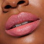 Lips wearing ColourPop Lippie Stix in Felt Cute, a creamy soft pink, reflecting a glossy satin sheen; extreme close-up shows full, even coverage and smooth, hydrated texture for a natural everyday lip look.