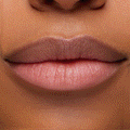 Model’s lips wear ColourPop pH Lip Balm, Sing, tinting to a custom soft pink with a glossy, hydrated finish; close-up studio shot on medium skin showcases the pH‑reactive color, smooth texture, and subtle shine.