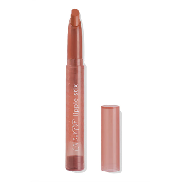 ColourPop Parker Lippie Stix stands uncapped with the bullet extended, showing a warm terracotta nude; translucent dusty-rose tube with white branding, matching cap set beside it on a clean white background.