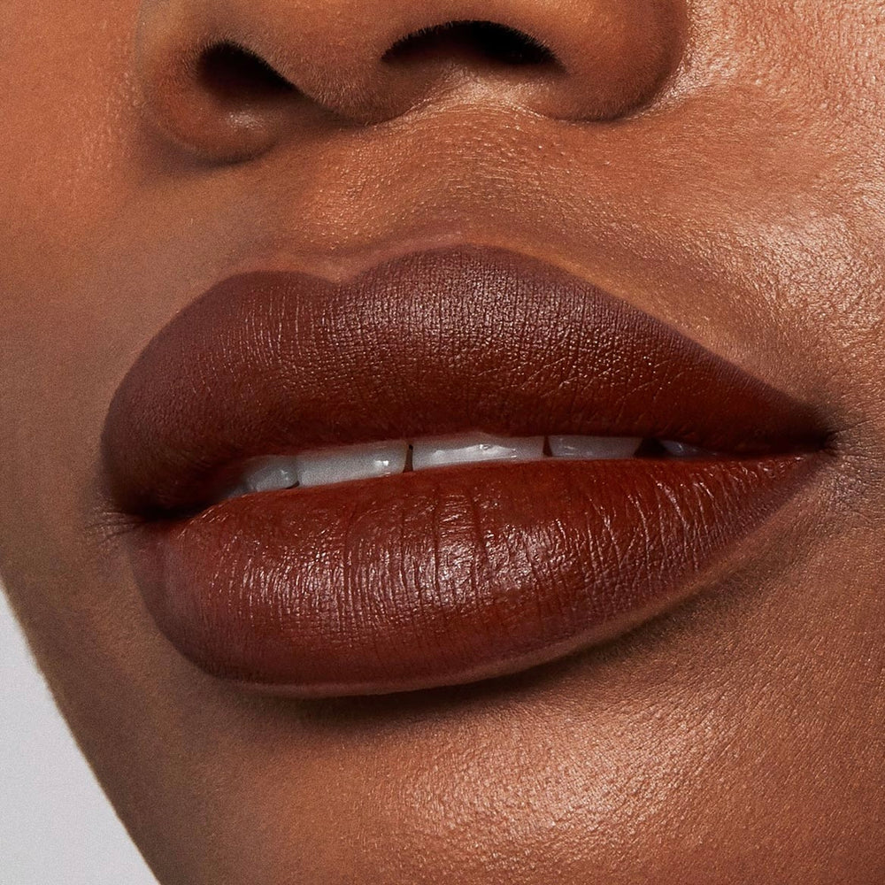 Full lips lined and filled with Pitch, a rich chocolate-brown ColourPop Lippie Pencil, showing smooth, saturated color and sharp definition in a studio close-up.