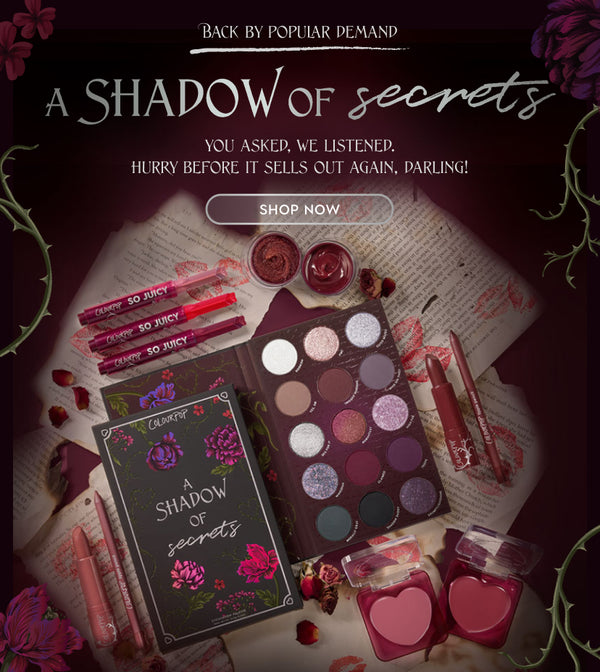 ColourPop A Shadow of Secrets palette showcasing 15 mauve, berry, and shimmer shades, styled with So Juicy glosses, satin lipstick, lip liner, and two heart-shaped blush compacts on lipstick-stamped pages and roses in a moody restock flat lay.