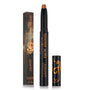 Vampire Girl ColourPop Shadow Stix stands uncapped, revealing a multichrome green-to-red shimmer tip, with its black cap and matching New Moon Twilight collab box beside it, both in black with copper-gold graphics, on a white backdrop.