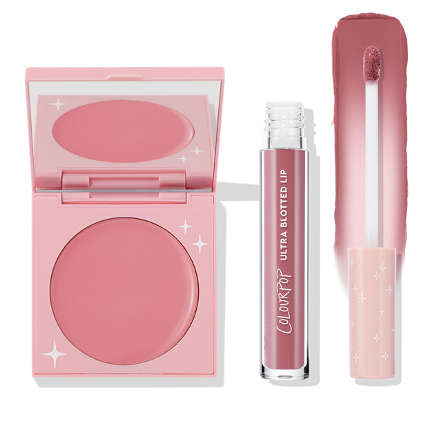 That’s So Rosy ColourPop Cheek & Lip Set featuring a rosy pink cream blush in a pink compact with star accents and a matching Ultra Blotted Lip tube with doe-foot and swatch strip, arranged on a white background for a soft monochrome look.
