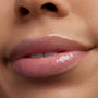 Glossy nude-pink lips wear ColourPop Ultra Glossy Lip in Favorite Deputy, sparkling with fine shimmer in a macro close-up, showing a smooth, glassy, hydrated finish.