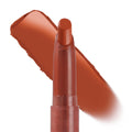 Ziggie Lippie Stix by ColourPop standing upright with tip exposed, a warm terracotta-brown swatch swept behind to show creamy matte payoff on a white background; ColourPop Lippie Stix product close-up.