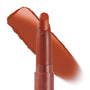 Ziggie Lippie Stix by ColourPop standing upright with tip exposed, a warm terracotta-brown swatch swept behind to show creamy matte payoff on a white background; ColourPop Lippie Stix product close-up.