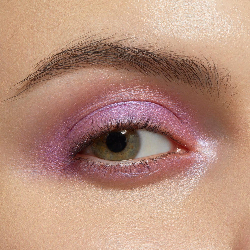 Eye showcasing Hey Bestie ColourPop Shadow Stix, a shimmery lilac‑pink eyeshadow swept across the lid and lower lash line with a pearly inner‑corner highlight, creamy blend, and luminous finish in a close-up beauty swatch.