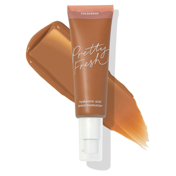 ColourPop Pretty Fresh Tinted Moisturizer, Dark 17 N, angled tube with white pump labeled “hyaluronic acid tinted moisturizer,” set over a wide deep-brown swatch on a white background to show shade and coverage.