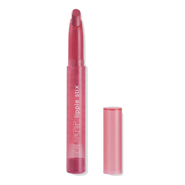 ColourPop Lippie Stix Byron Babe standing uncapped, rosy pink bullet twisted up in a translucent pink tube with white “lippie stix” branding, cap set beside it on a clean white background, ready for precise lip color application.