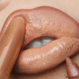Dream Date Lippie Stix applies to peach‑beige lips in an extreme close-up, with ColourPop Lippie Stix delivering creamy, glossy nude coverage and a precise tip for a soft everyday look.