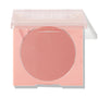 ColourPop Pressed Powder Blush in To the 10 sits half-open, revealing a matte peachy-rose pan inside a blush-pink compact with a clear lid, shown on a white background for crisp product detail.