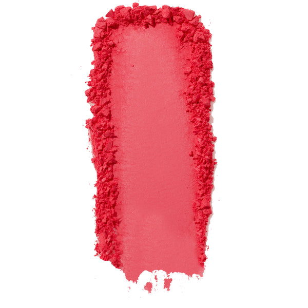ColourPop Pressed Powder Blush Woo Me swatch - vibrant coral pink pigment swept in a thick vertical streak with a smooth center and crumbled edges, showing buildable payoff and texture on a clean white background.